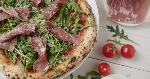 Delicious Pizza with Prosciutto Parma Ham Arugula Salad Rocket with Ingredients