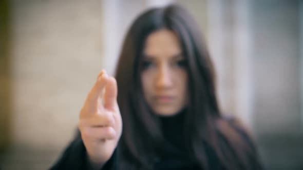 Defocused woman Gun To camera And Shooting Hand Gesture-slow motion