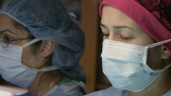 Female Surgeon Performing Surgery (1 Of 2)