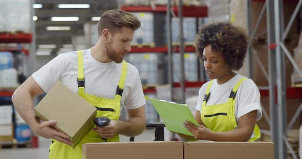 Diverse Colleagues Doing Inventory in Warehouse Scanning Barcode
