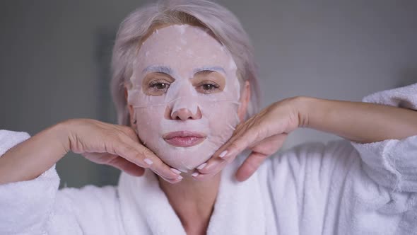 Gorgeous Middle Aged Woman in Face Mask Gesturing Air Kiss Smiling Looking at Camera