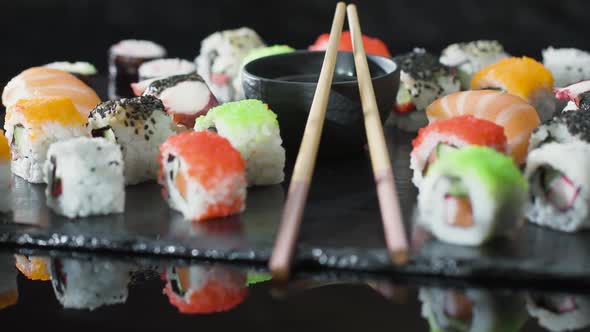 Rolls, Sushi, Maki on a  Stone Plate in a Japanese Sushi Bar.
