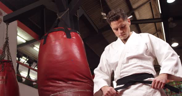 Man in black belt standing in fitness studio