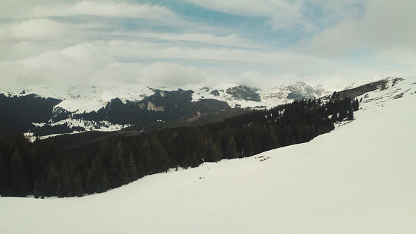 Flying Above Snow Revealing the Mountains