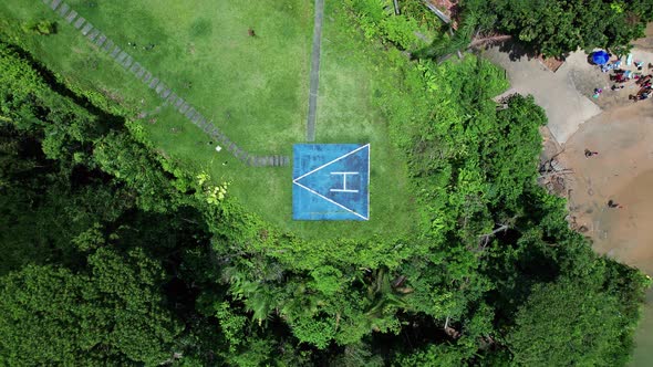 Aerial birdseye rising from helipad revealing coastal scene of Ubatuba, Brazil