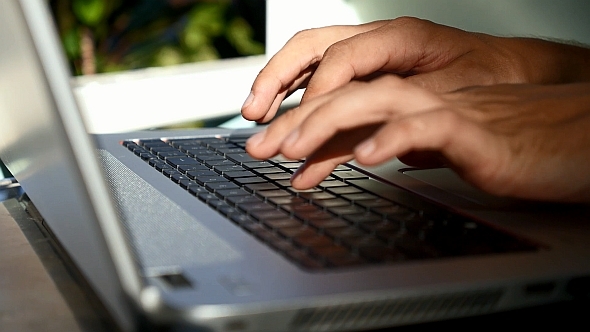 Male Hands Typing on Laptop