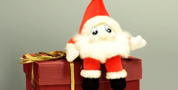 Christmas Gnome Jumping on a Holiday Present