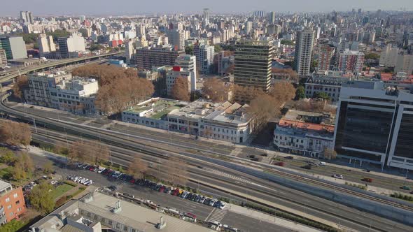 Aerial view of Puerto Madero waterway with buildings at sides at daytime. Dolly left