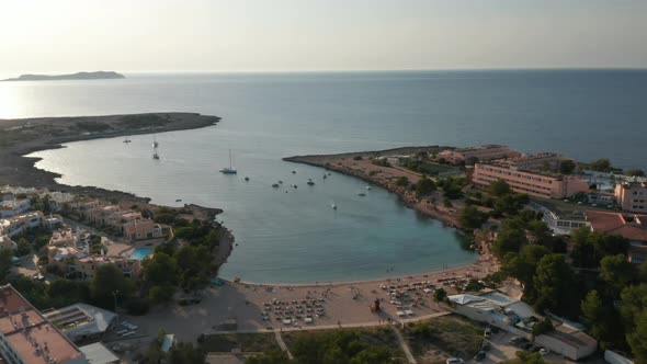 Aerial Panoramic Slow Motion View of a Crowd of Unrecognizable People Relaxing and Enjoying at Beach