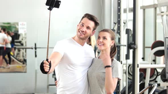 Cheerful Couple Taking Selfie at Gym