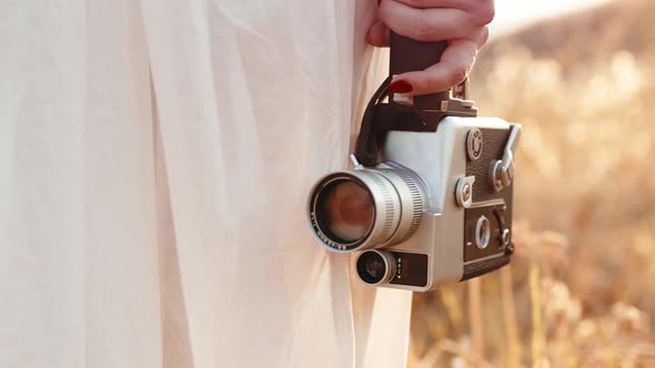 Hand of Woman with a Vintage Movie Camera