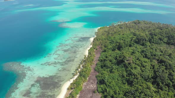 Aerial: flying over exotic white sand beach tropical island secluded destination away from it all