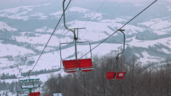 View of the Ski Lift Against the Background of a Mountain Forest and Gray Sky in the Carpathians