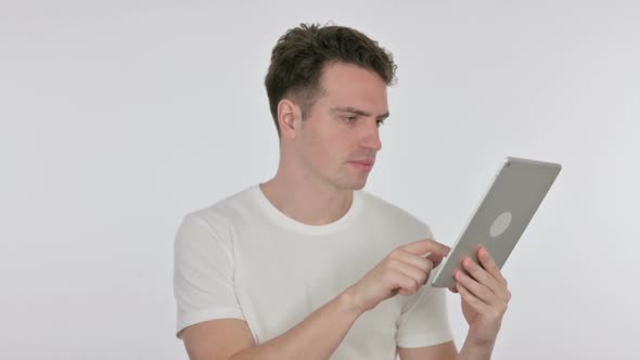 Young Man Reacting to Loss on Tablet on White Background