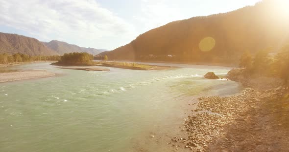 Low Altitude Flight Over Fresh Fast Mountain River with Rocks at Sunny Summer Morning