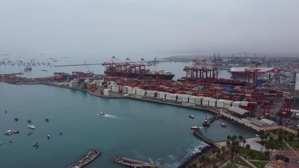 Drone video of seaport of Callao, Peru. Recorded on a cloudy morning from far away. 2 big ships dock