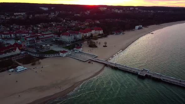 Cinematic pier in the sunset from a bird's eye view. Filming at sunset in Sopot.