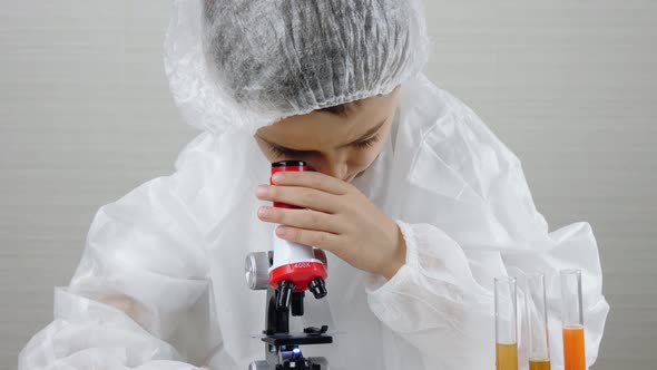 The Child Plays in a Medical Suit As a Laboratory Assistant