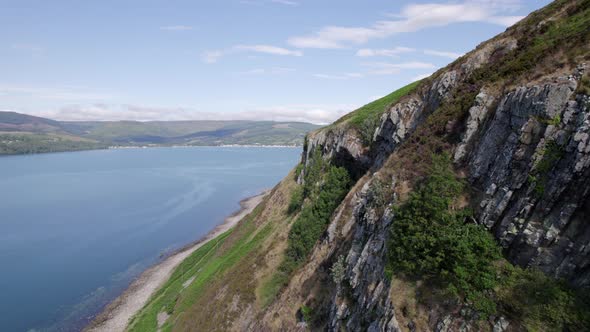 Flying Along the Coast of the Holy Isle in Scotland with Beautiful Mountains