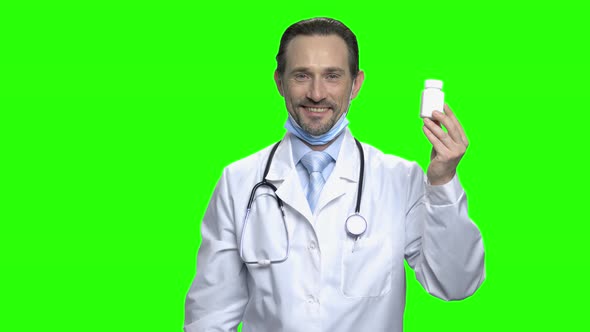 Friendly Male Doctor with White Bottle of Pills