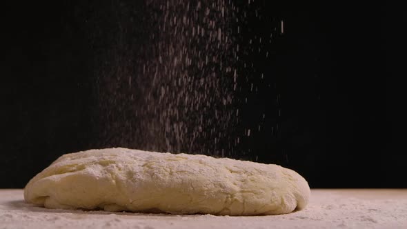 Sprinkle Flour on the Dough Lying on the Kitchen Table