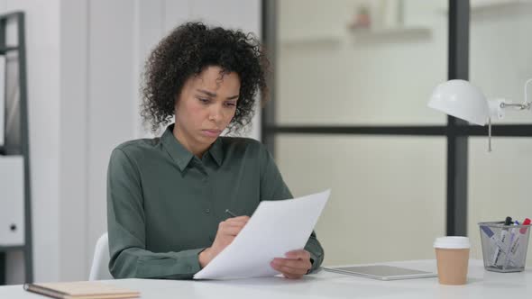 African Woman Reading Papers Work