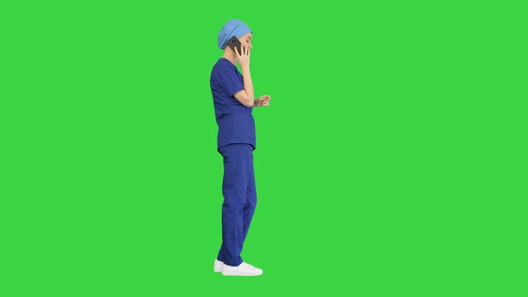 Serious Female Doctor Talking on the Phone on a Green Screen, Chroma Key