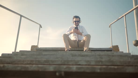 Businessman Relaxing Enjoying After Good News Having Fun Work Break Outdoors. Man Listening Music.