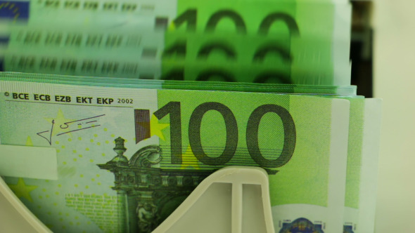 Banknote Counter and Stack of 100 Euro