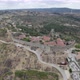 Aerial descending wide panoramic view of Sortelha village and wind turbines for eolic energy - VideoHive Item for Sale