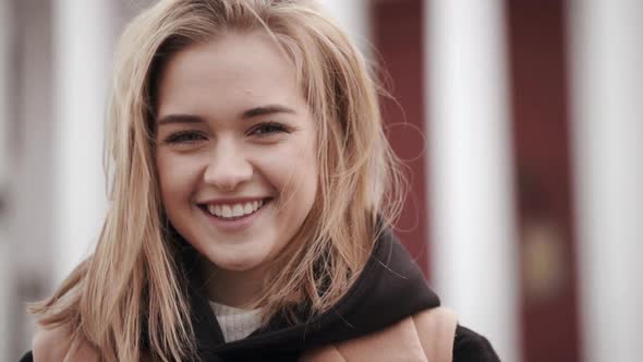 Closeup Portrait Showing Positive Emotions of Goodlooking Female Resting Outdoor Posing Against City