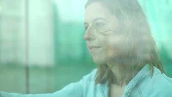 Woman looking through window