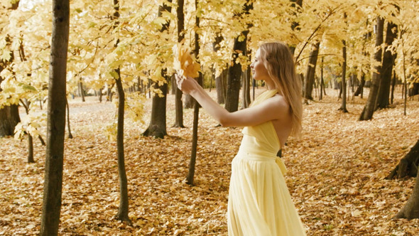 Happy Woman Walking Between Trees