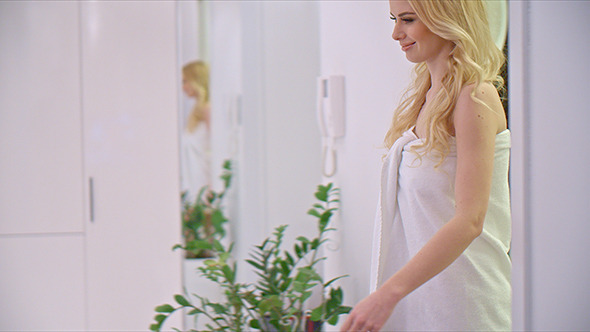 Blond Girl Walking in Her Apartment alt