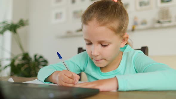 Schoolgirl Girl Doing Homework On Distance Learning