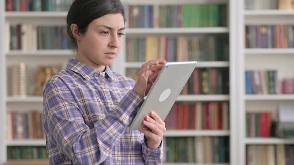 Portrait of Indian Woman using Tablet in Office