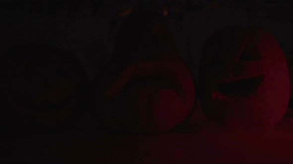 Carved Jack Lantern Pumpkins With Smoke in Red Light Darkness, Halloween Party