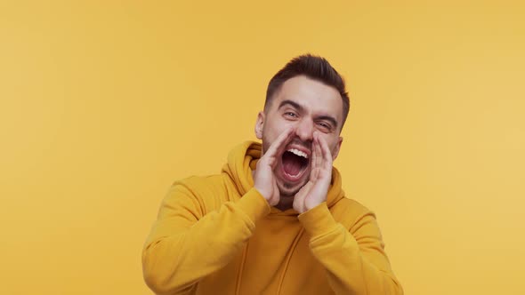 Expressive young man screaming and shouting over vibrant background.