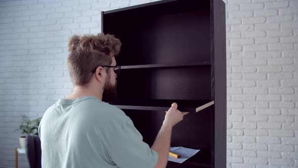 Bearded Man Assembling New Furniture at Home