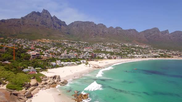 Aerial travel drone view of Camps Bay beach, Cape Town, South Africa.