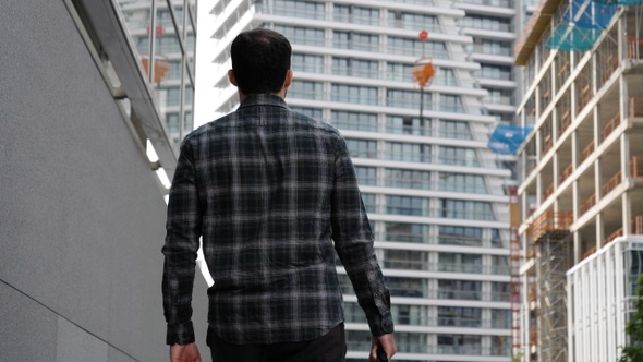 Young Man Walking to The Modern Building.