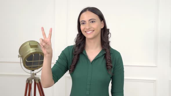 Indian woman showing victory sign