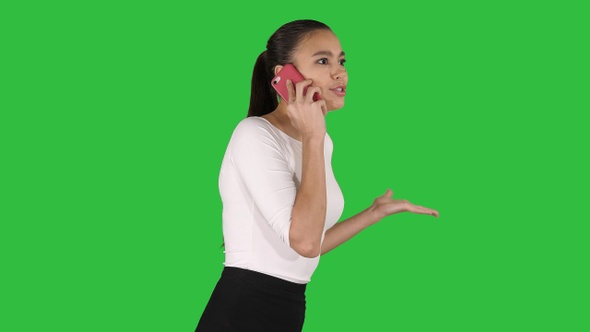 Stressed businesswoman with mobile phone making a call
