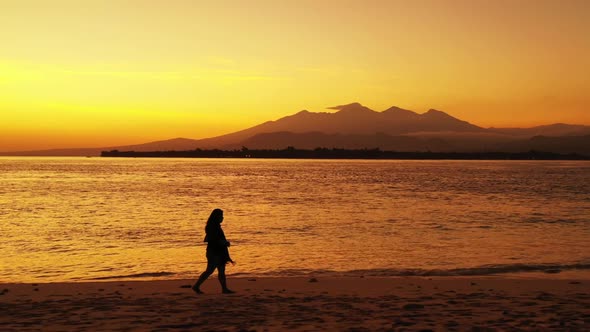 Lady alone suntans on perfect shore beach journey by shallow ocean with clean sandy background of th