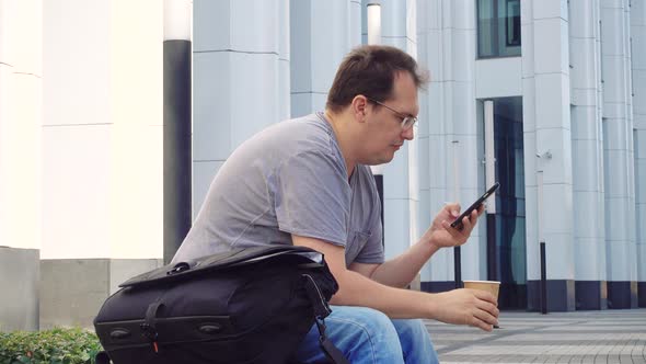 Man with Cup of Coffee Outdoors