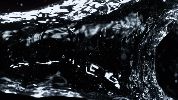 Super Slow Motion Detail Shot of Water Stream Isolated on Black Background at 1000Fps