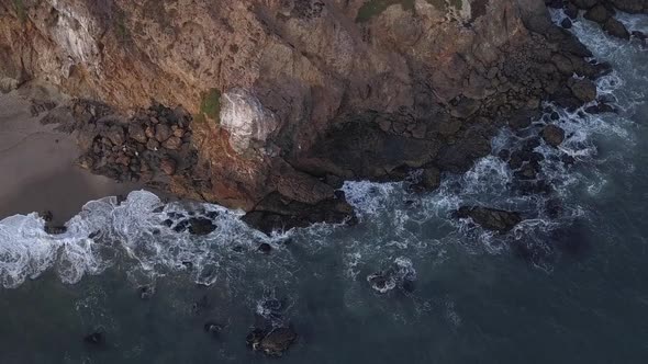 AERIAL: Flight Over Malibu, California View of Beach Shore Line Pacific Ocean at Sunset with