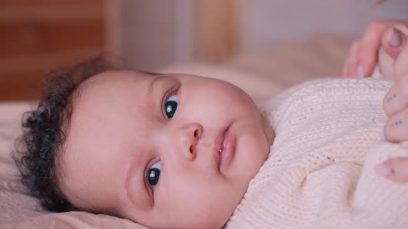 A Woman is Kissing Her Newborn Daughter