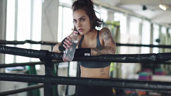 Girl Drinks Water in the Gym