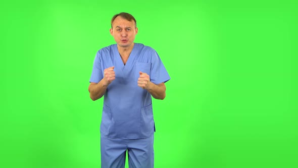 Medical Man Emotionally Watches Something, Comments and Then Rejoices in Victory, Green Screen